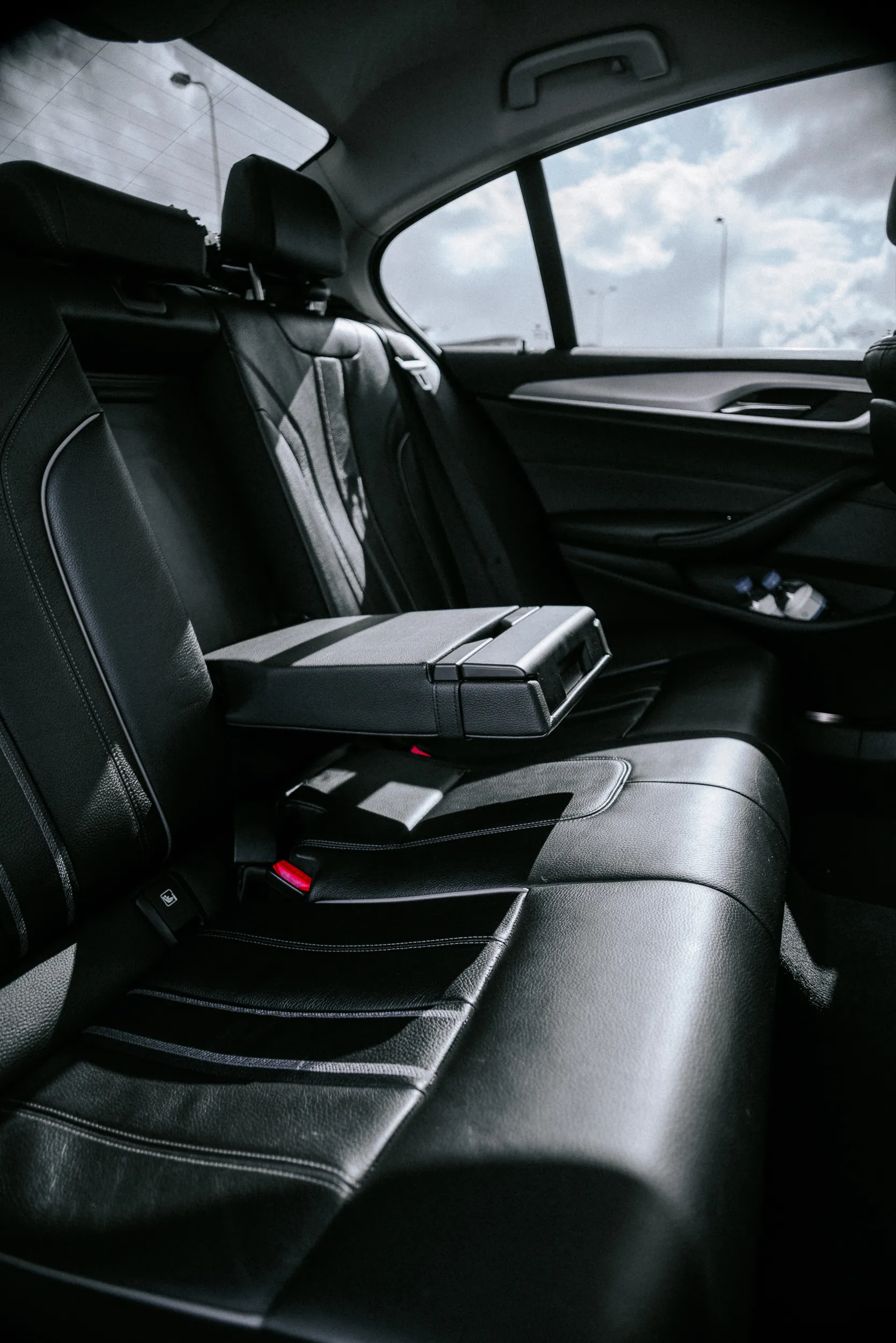 Rear passenger interior of BMW 5 Series business class vehicle with premium comfort